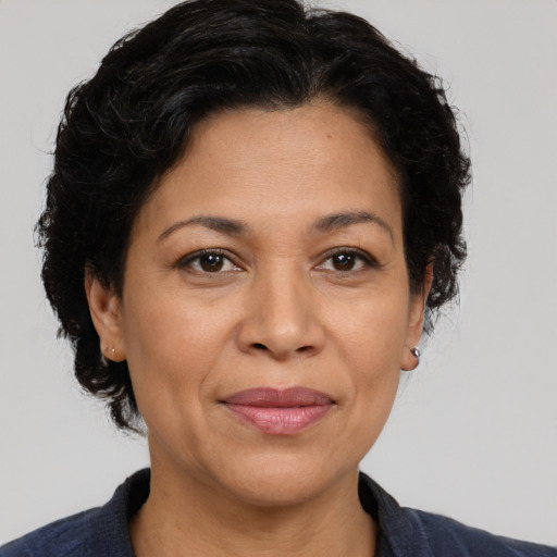 Joyful latino adult female with medium  brown hair and brown eyes