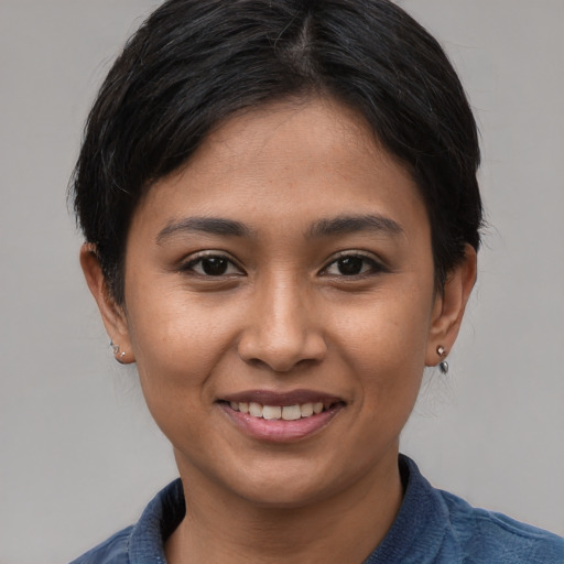 Joyful asian young-adult female with short  brown hair and brown eyes