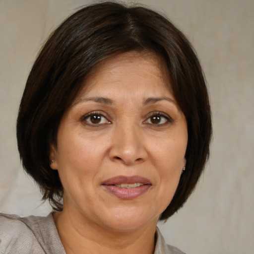 Joyful white adult female with medium  brown hair and brown eyes