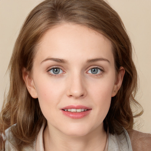 Joyful white young-adult female with medium  brown hair and blue eyes