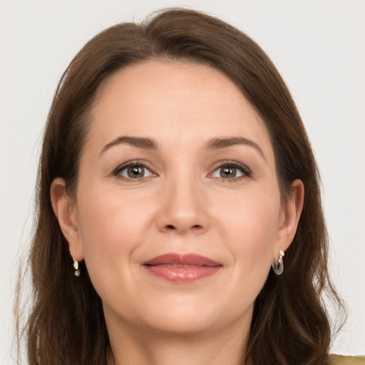 Joyful white adult female with long  brown hair and brown eyes