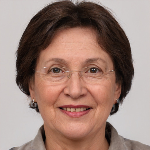 Joyful white middle-aged female with medium  brown hair and grey eyes