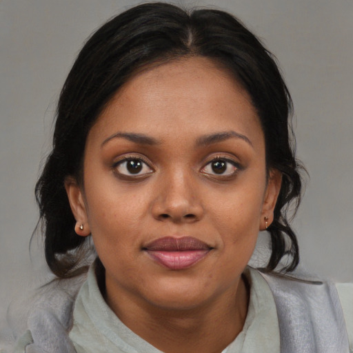Joyful black young-adult female with medium  brown hair and brown eyes