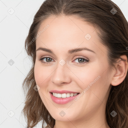 Joyful white young-adult female with long  brown hair and grey eyes