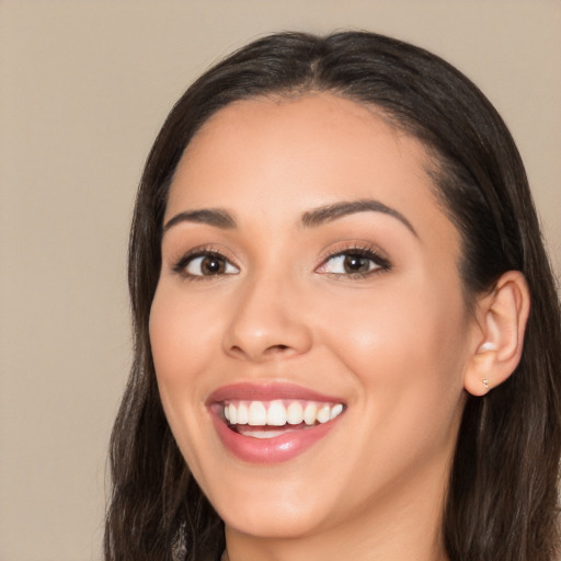 Joyful white young-adult female with long  black hair and brown eyes