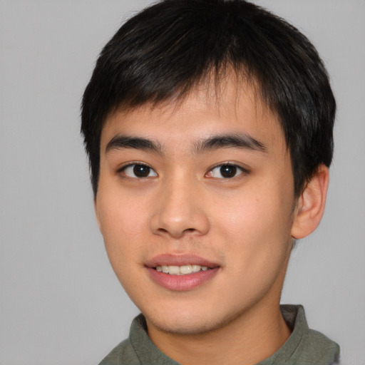 Joyful asian young-adult male with short  brown hair and brown eyes