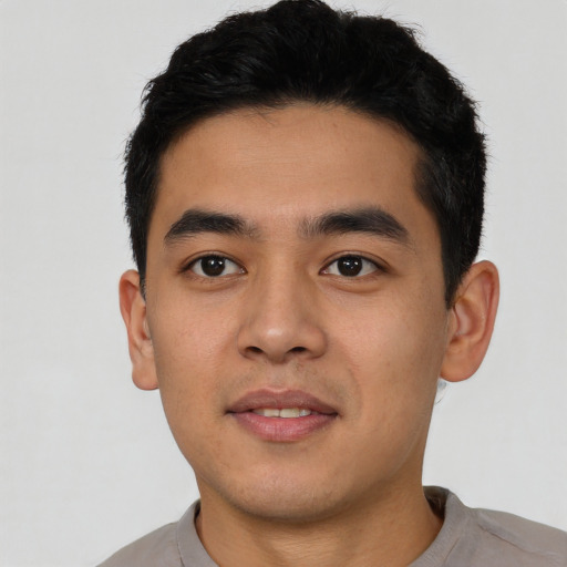 Joyful asian young-adult male with short  black hair and brown eyes