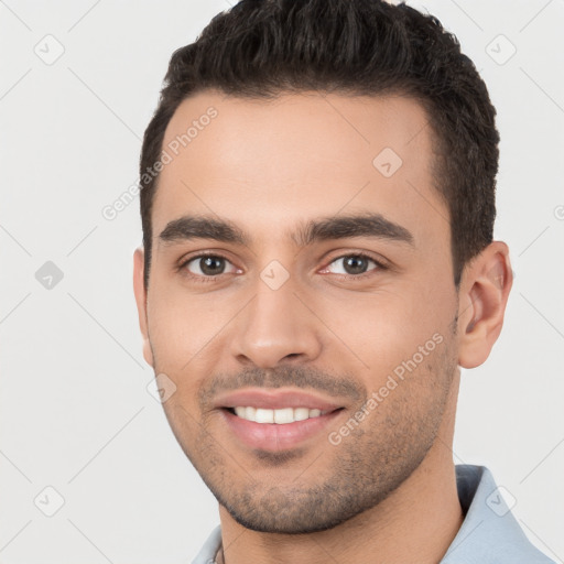 Joyful white young-adult male with short  brown hair and brown eyes