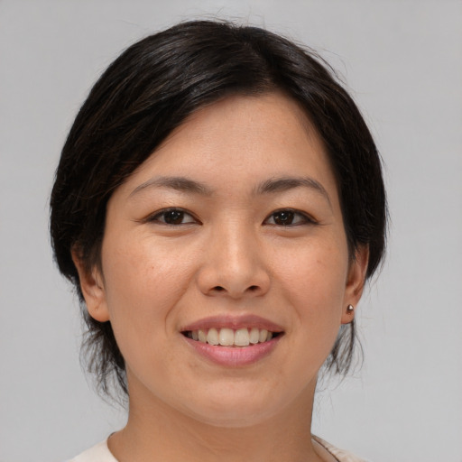 Joyful white young-adult female with medium  brown hair and brown eyes