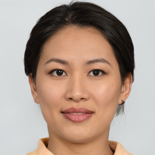 Joyful asian young-adult female with short  brown hair and brown eyes