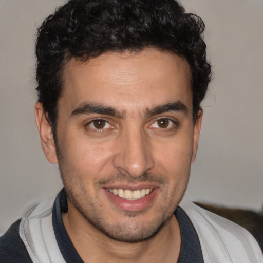 Joyful white young-adult male with short  black hair and brown eyes