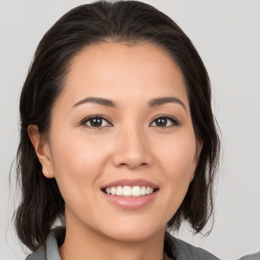 Joyful white young-adult female with medium  brown hair and brown eyes