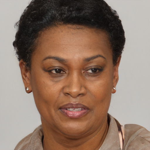 Joyful black adult female with short  brown hair and brown eyes