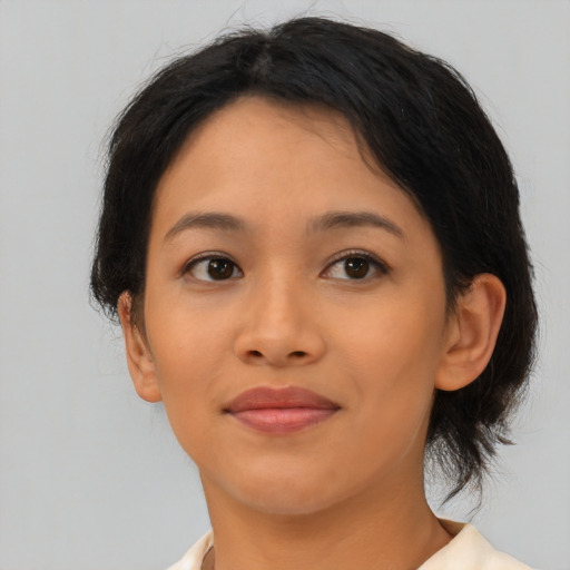 Joyful asian young-adult female with medium  brown hair and brown eyes