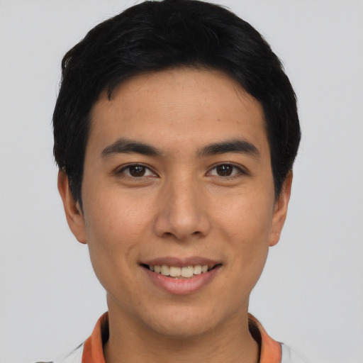 Joyful asian young-adult male with short  black hair and brown eyes