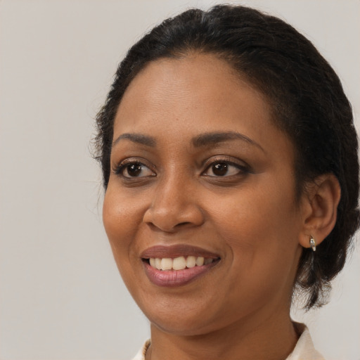 Joyful black young-adult female with medium  brown hair and brown eyes