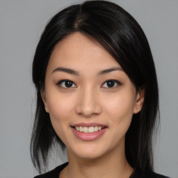 Joyful asian young-adult female with medium  black hair and brown eyes