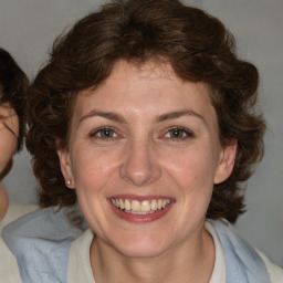 Joyful white adult female with medium  brown hair and blue eyes