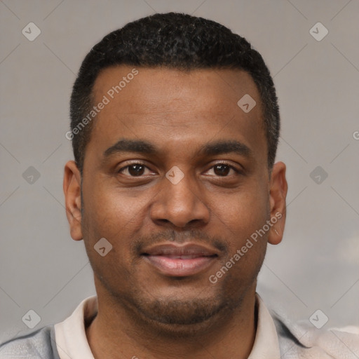 Joyful latino young-adult male with short  brown hair and brown eyes