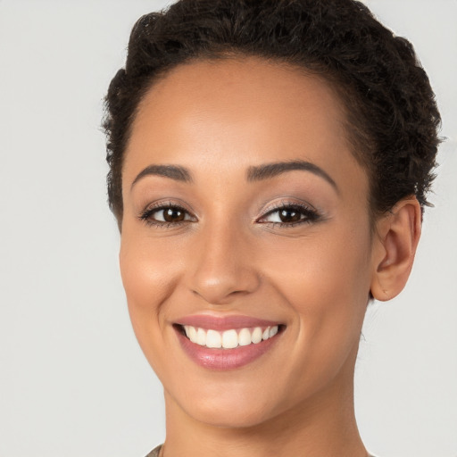 Joyful white young-adult female with short  brown hair and brown eyes