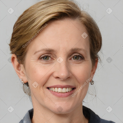 Joyful white adult female with medium  brown hair and blue eyes