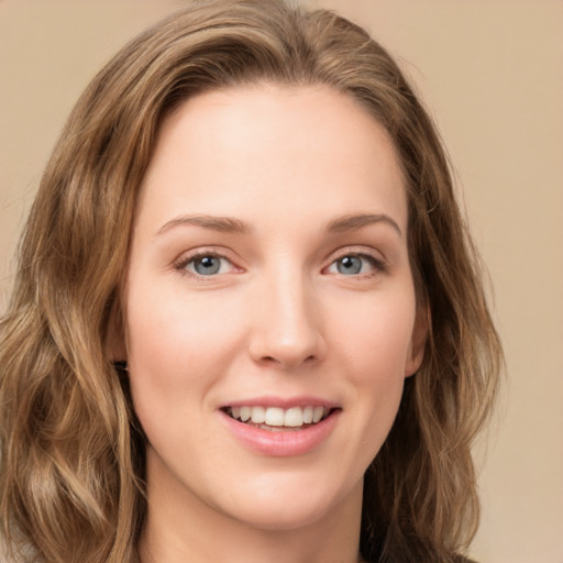 Joyful white young-adult female with long  brown hair and green eyes