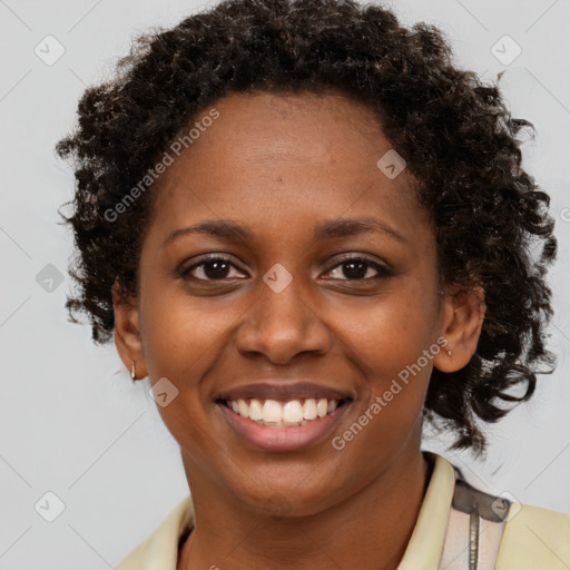 Joyful black young-adult female with medium  brown hair and brown eyes