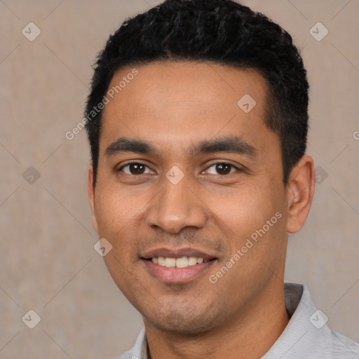 Joyful latino young-adult male with short  black hair and brown eyes