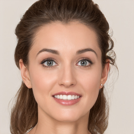 Joyful white young-adult female with medium  brown hair and green eyes