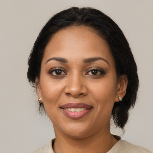 Joyful latino adult female with medium  black hair and brown eyes