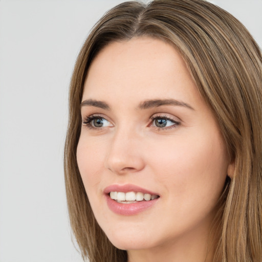 Joyful white young-adult female with long  brown hair and green eyes