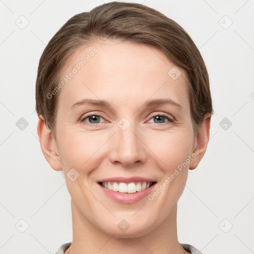 Joyful white young-adult female with short  brown hair and grey eyes