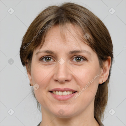 Joyful white adult female with medium  brown hair and grey eyes