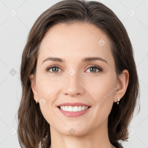 Joyful white young-adult female with medium  brown hair and grey eyes