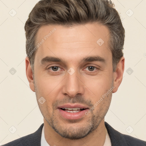 Joyful white adult male with short  brown hair and brown eyes