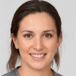 Joyful white young-adult female with medium  brown hair and brown eyes