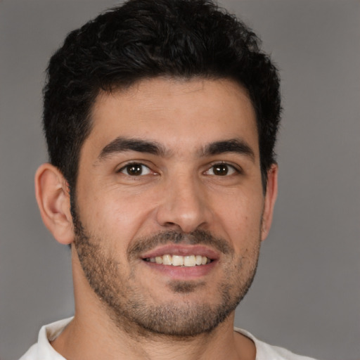 Joyful white young-adult male with short  black hair and brown eyes