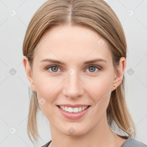 Joyful white young-adult female with medium  brown hair and grey eyes