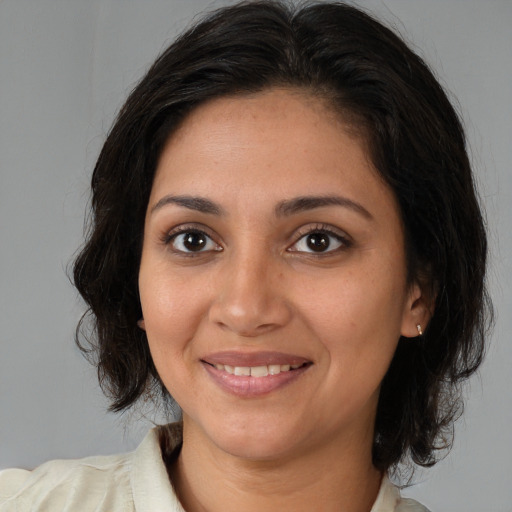 Joyful white young-adult female with medium  brown hair and brown eyes