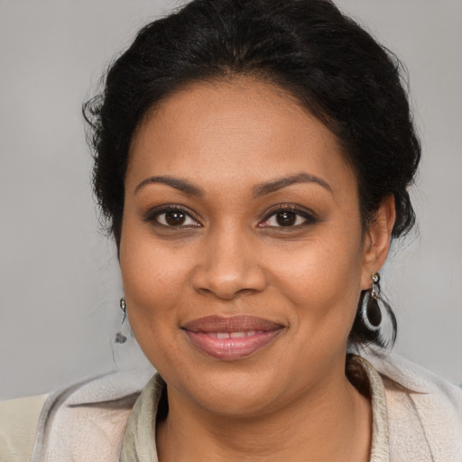 Joyful black young-adult female with medium  brown hair and brown eyes