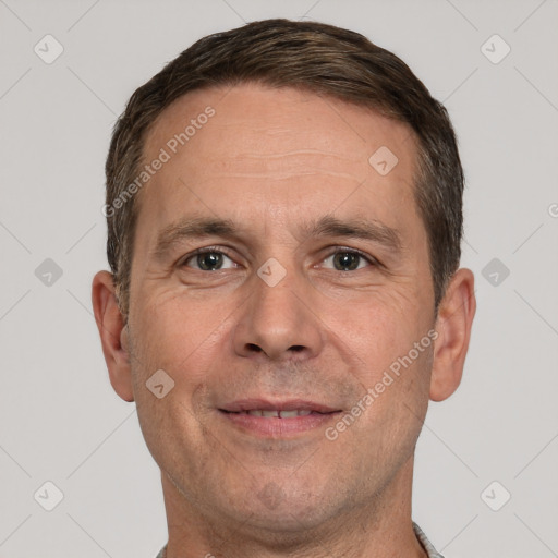 Joyful white adult male with short  brown hair and brown eyes