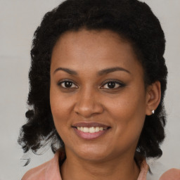 Joyful black young-adult female with medium  brown hair and brown eyes