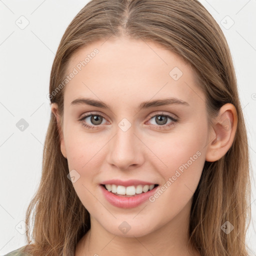 Joyful white young-adult female with long  brown hair and blue eyes