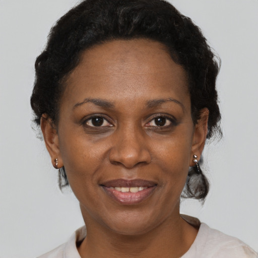 Joyful black adult female with short  brown hair and brown eyes