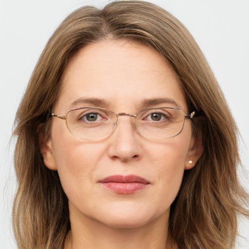 Joyful white adult female with long  brown hair and grey eyes