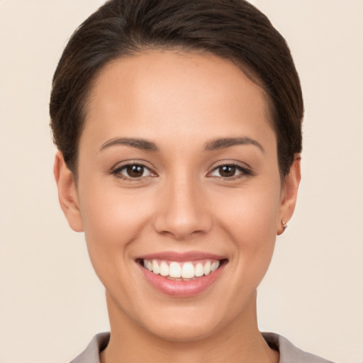 Joyful white young-adult female with short  brown hair and brown eyes