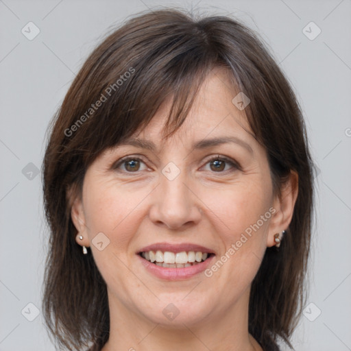 Joyful white adult female with medium  brown hair and brown eyes