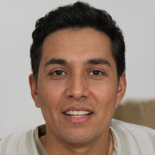 Joyful white adult male with short  black hair and brown eyes