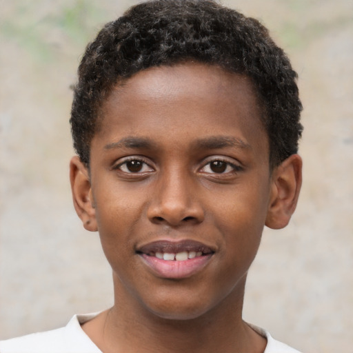 Joyful black child male with short  brown hair and brown eyes