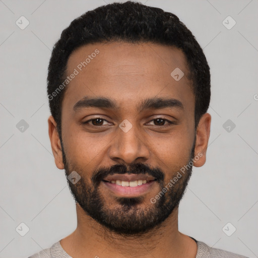 Joyful black young-adult male with short  black hair and brown eyes